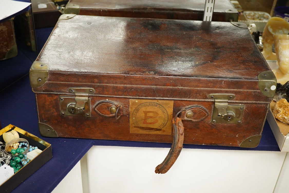 An early 20th century leather travelling toilet case, with 'Peninsular & Oriental Steam Navigation Compy' paper labels, containing eight French 950 standard white metal mounted glass toilet jars and one English silver mo